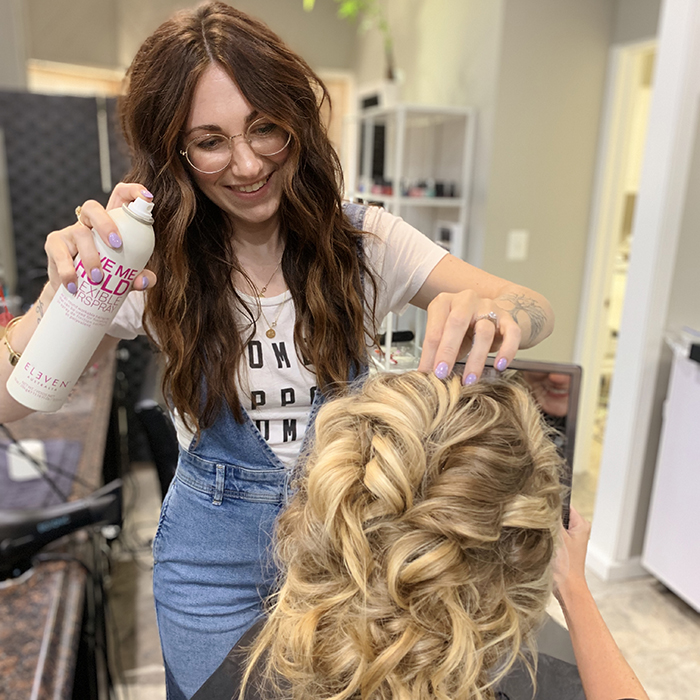 Chelsea Laurèn fixes a blonde model during an education class at Tacari Salon.